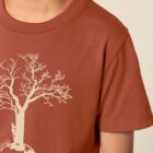 Tshirt enfant manche courte couleur terracotta avec le dessin d'un arbre sur une planète et sérigraphie de couleur beige.