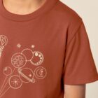 Tshirt enfant manche courte en coton biologique de couleur terracotta avec un dessin représentant des planètes en forme de ballons tenu par le petit prince et son renard. La couleur de sérigraphie est beige.