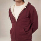 Photo de présentation du sweat à capuche zippé unisexe Polaire, en coton biologique, coloris bordeaux, porté par un modèle homme. Collection Ardecho 07. Zoom sur la polaire.